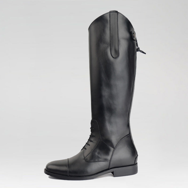 Black riding boot on a light gray background