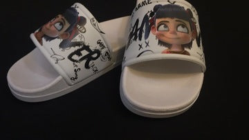 Pair of white slides with cartoon character design on a black background