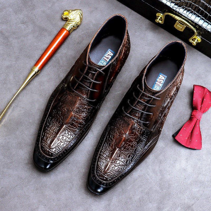 Brown crocodile-patterned dress shoes on a gray surface with a walking cane and red bow tie.