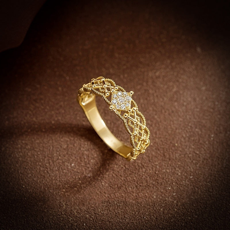 Gold ring with diamond on a brown textured background