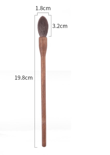 Wooden makeup brush with measurements on a white background