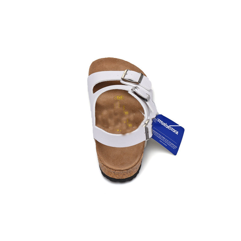 White sandal with a visible brand tag on a white background