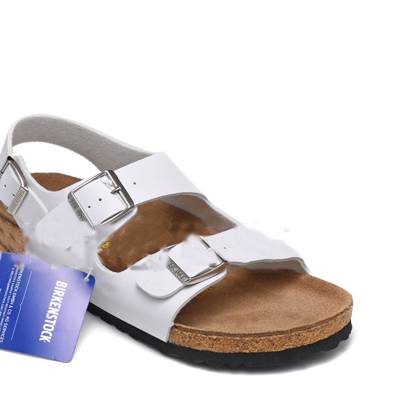 White sandal with brown sole and Birkenstock tag on a white background