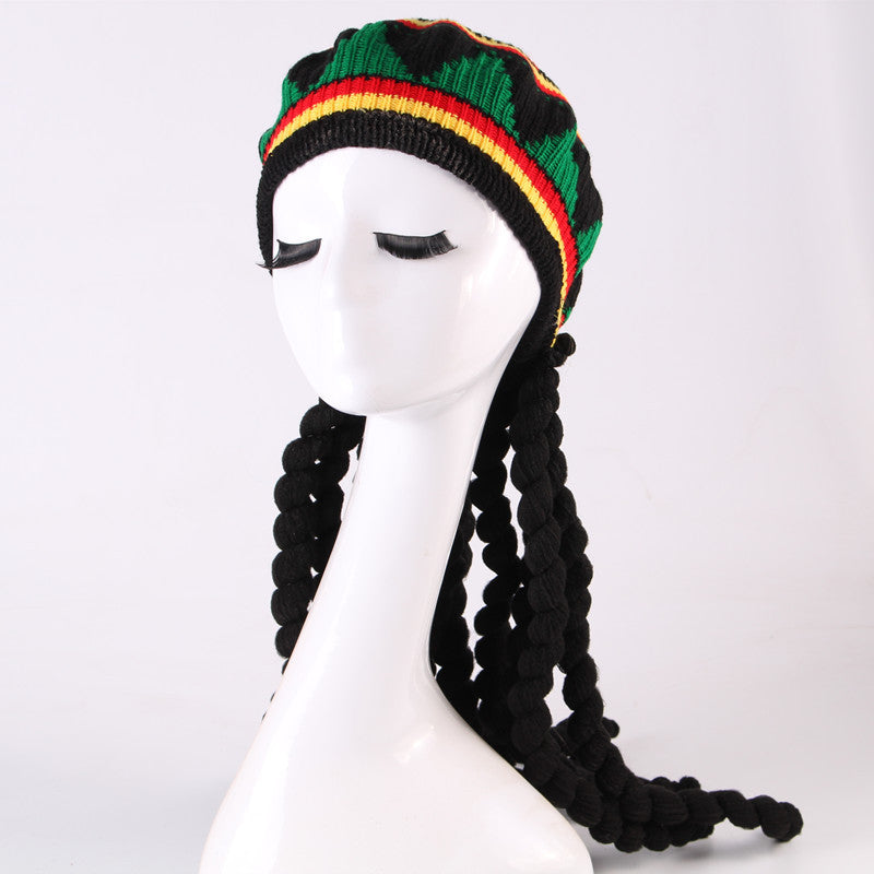 Mannequin head wearing a Rastafarian-style beanie with braided hair on a white background