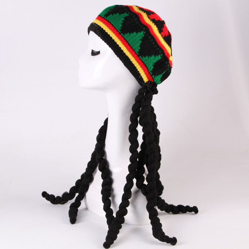 Knitted hat with braided black hair on a mannequin head against a white background