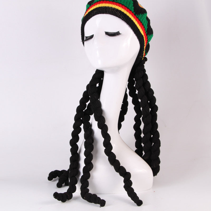Mannequin head wearing a colorful beanie with braided black hair on a white background