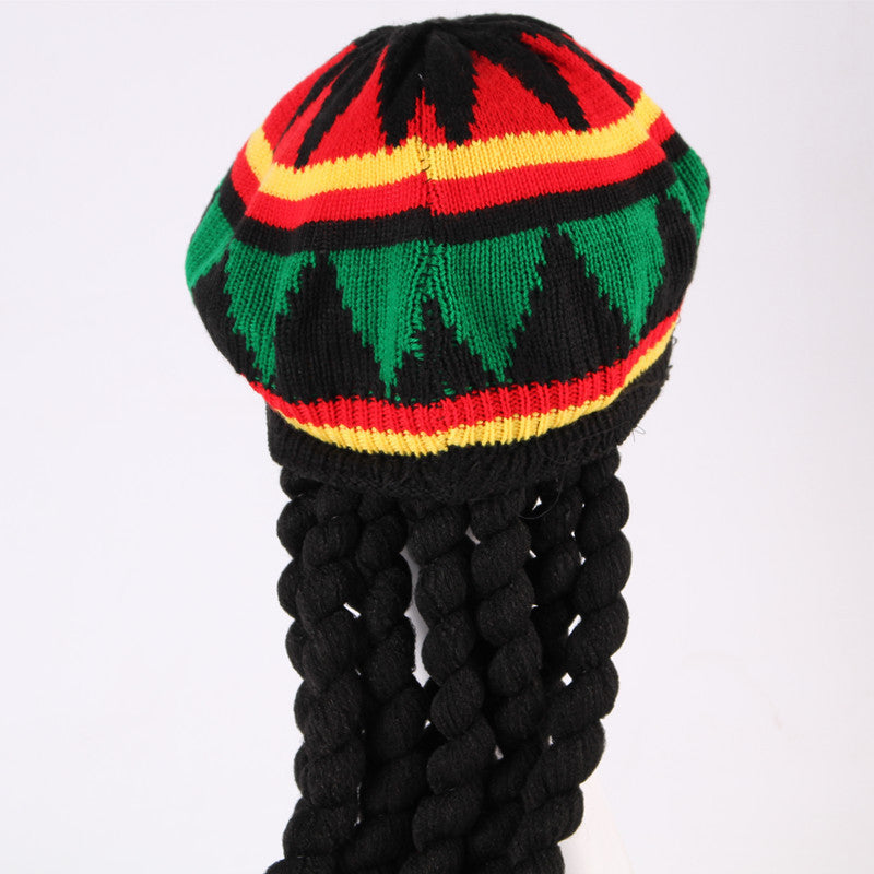 Colorful knitted hat with braided black hair on a white background