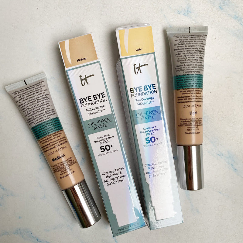 Two tubes of 'It' Bye Bye Foundation' on a light background