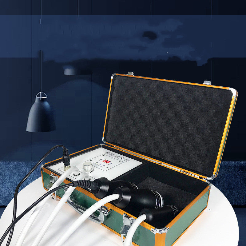 Open briefcase with electronic equipment on a white surface against a dark blue wall.