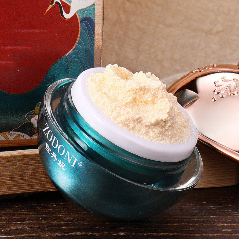 Cosmetic jar with cream on a wooden surface
