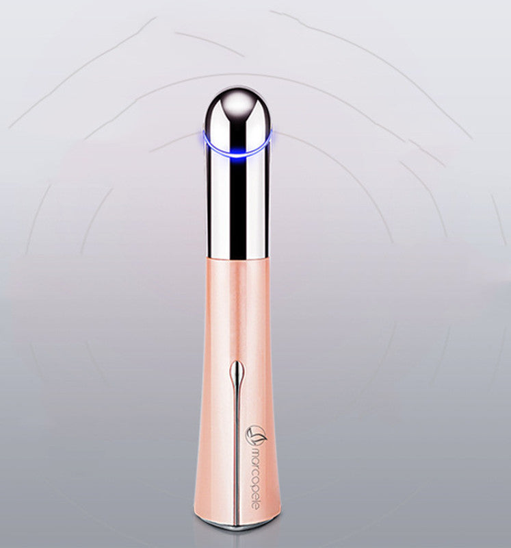 Rose gold and silver skincare device on a light gray background