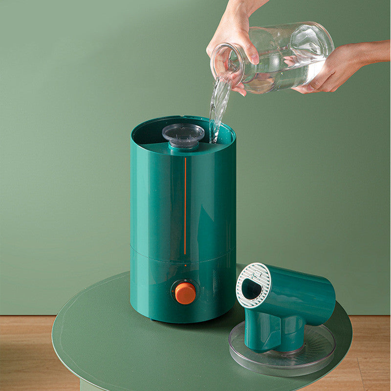 Green water dispenser with a person pouring water into it against a green background