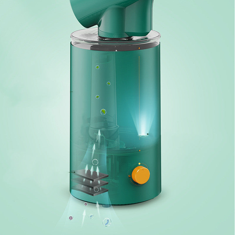Green juicer with a clear container on a light green background