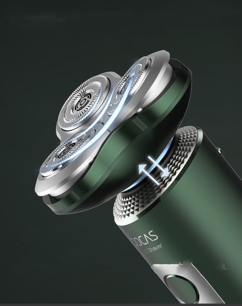 Close-up of a green and silver electric shaver on a dark background