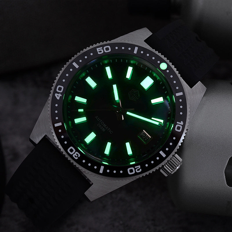 Watch with green glowing face on a dark background