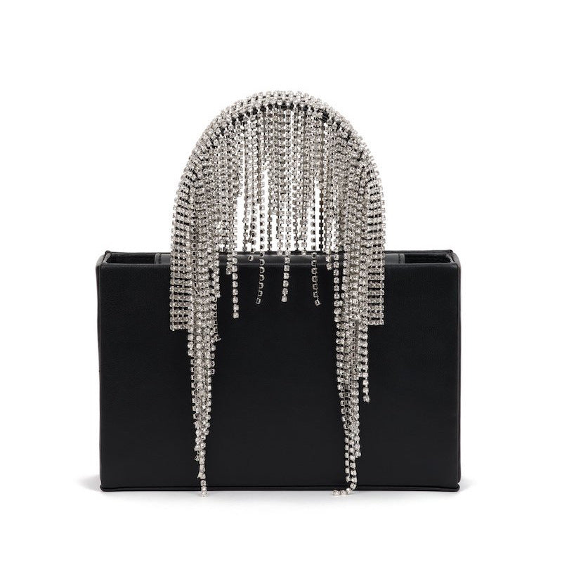 Black clutch with silver chain fringe on a white background