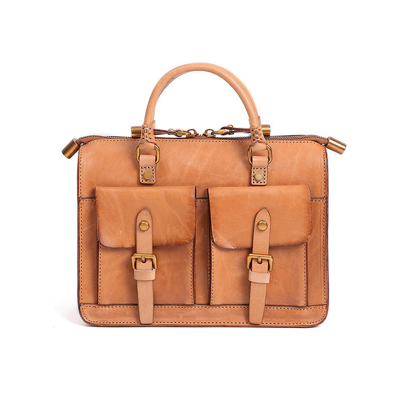 Brown leather satchel bag with gold accents on a white background