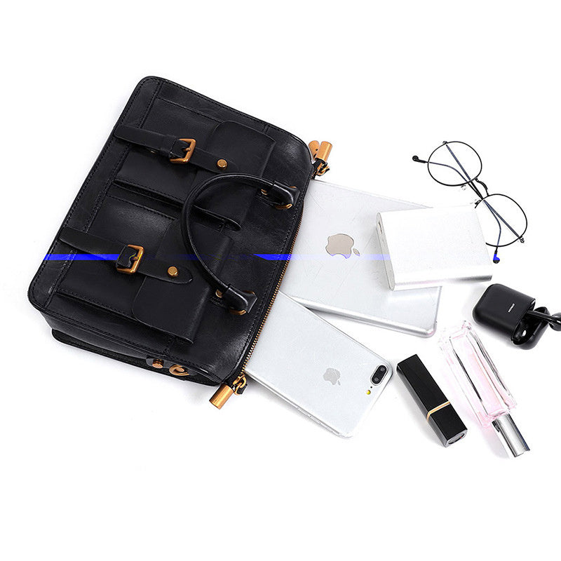 Black backpack with Apple products and accessories on a white background