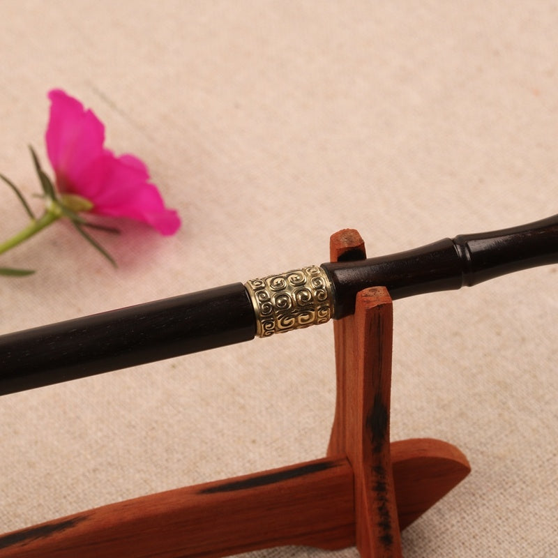 Decorative sword with ornate handle on a beige background