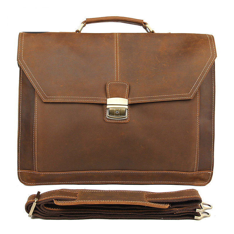 Brown leather briefcase with strap on a white background