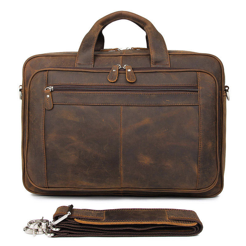 Brown leather briefcase with a strap on a white background
