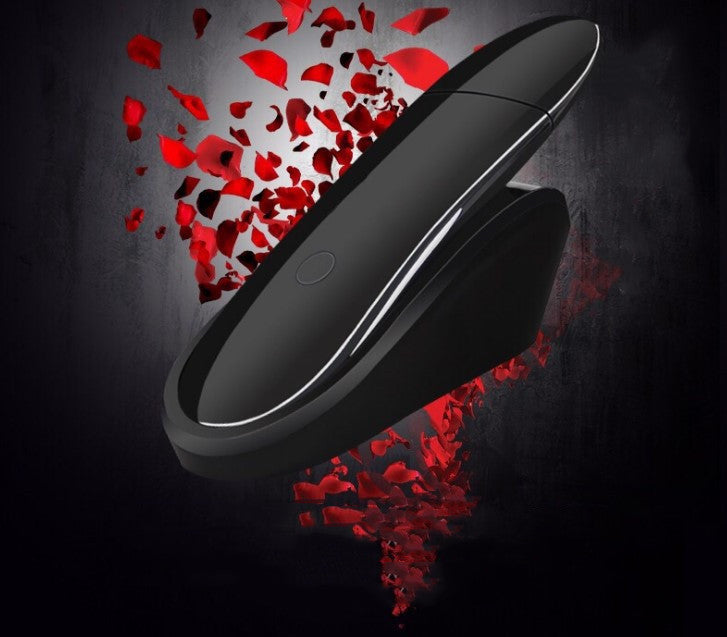 Black circular object with red heart-shaped fragments on a dark background