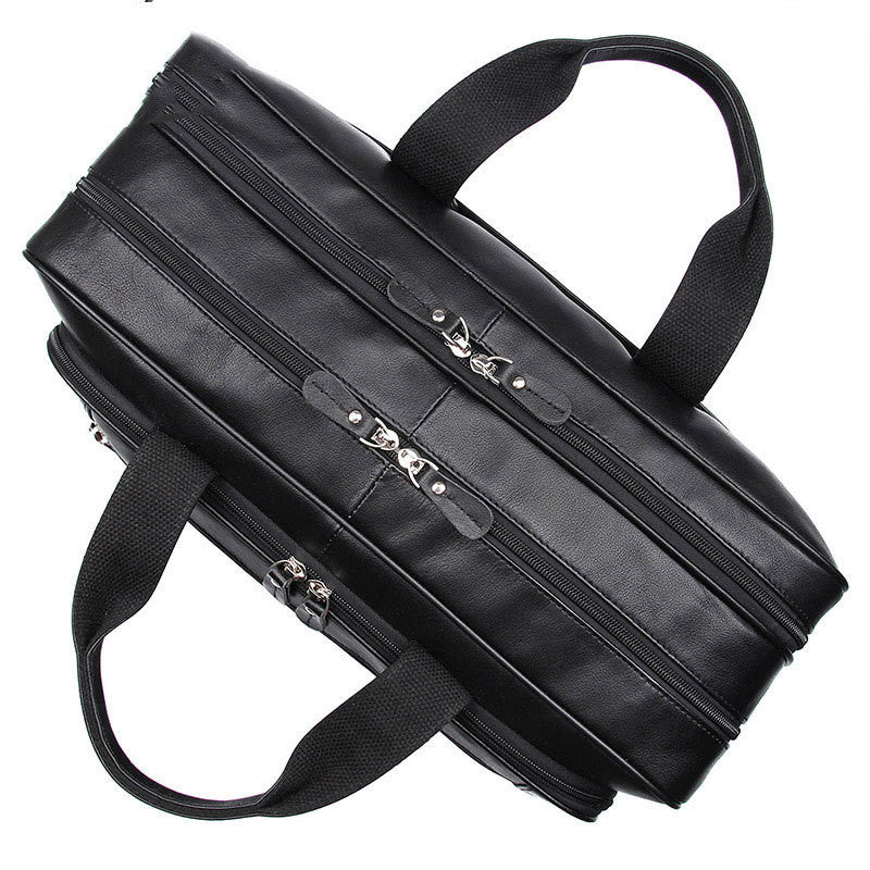 Black briefcase with multiple zippers on a white background