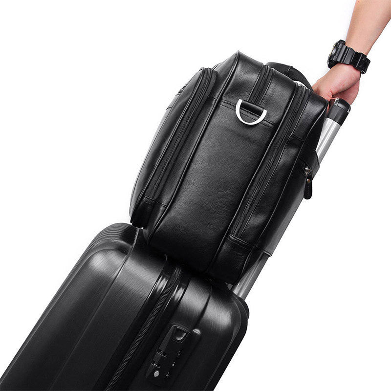 Black suitcase with a handle being held by a person on a white background