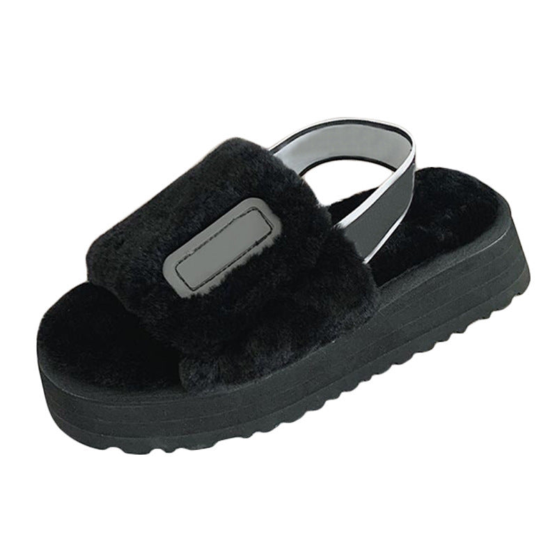 Black fuzzy slide sandal on a white background