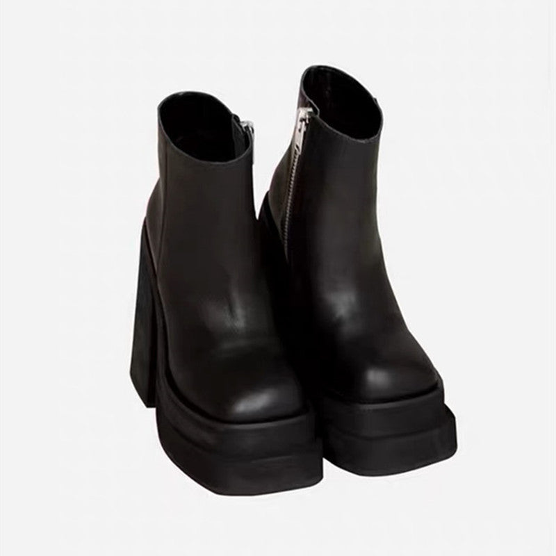 Pair of black platform ankle boots on a white background