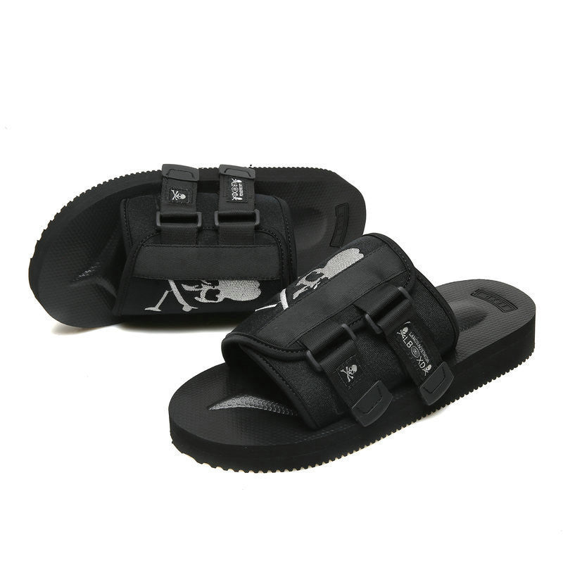 Black sandals with buckles on a white background