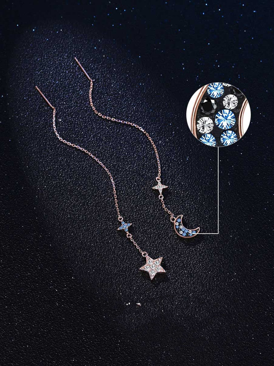 Necklace with star and moon pendants on a black background