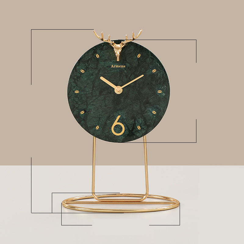 Decorative clock with green marble-like face and gold stand on a beige background