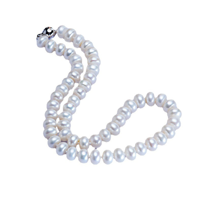 Pearl necklace and bracelet set on a white background
