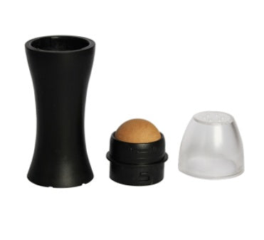 Black makeup roller with brown ball, black container, and clear cap on a white background
