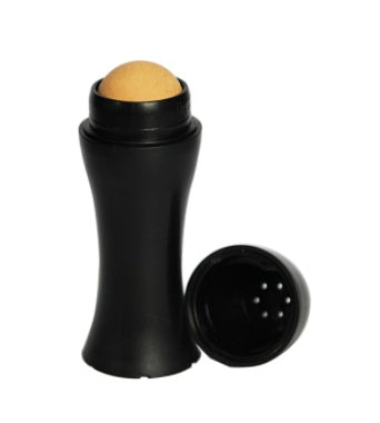 Black makeup stick with beige cap on a white background