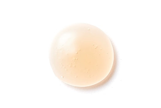 Round beige bar of soap on a white background