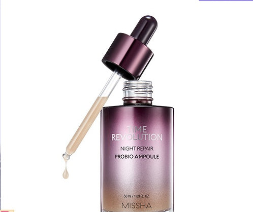 Cosmetic bottle with dropper labeled 'Time Revolution Night Repair Probió Ampoule' by Missha on a white background.