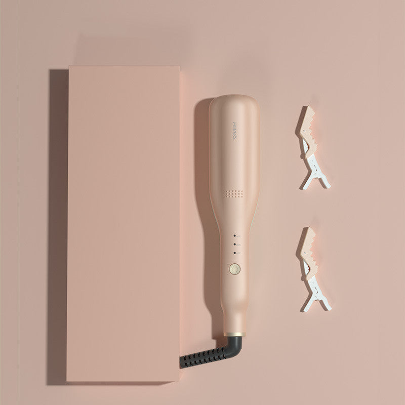 Hair straightener on a pink background with cut-out letters spelling 'OXO'.