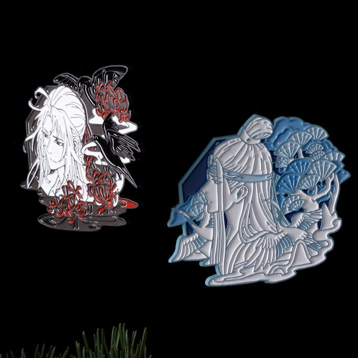 Two decorative pins featuring artistic designs on a black background.