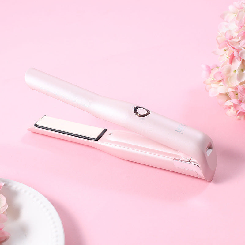 White hair straightener on a pink background with floral elements