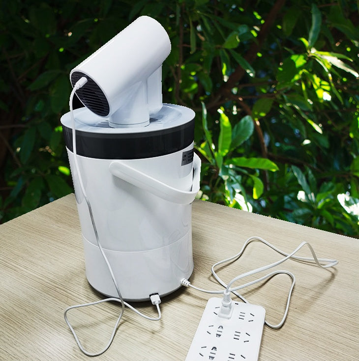 White hair dryer inside a white bucket on a wooden surface with green foliage in the background