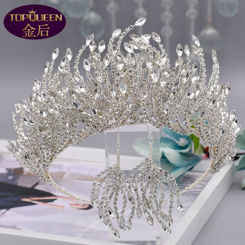 Silver tiara with intricate design on a magazine background, featuring the brand 'Topqueen'.