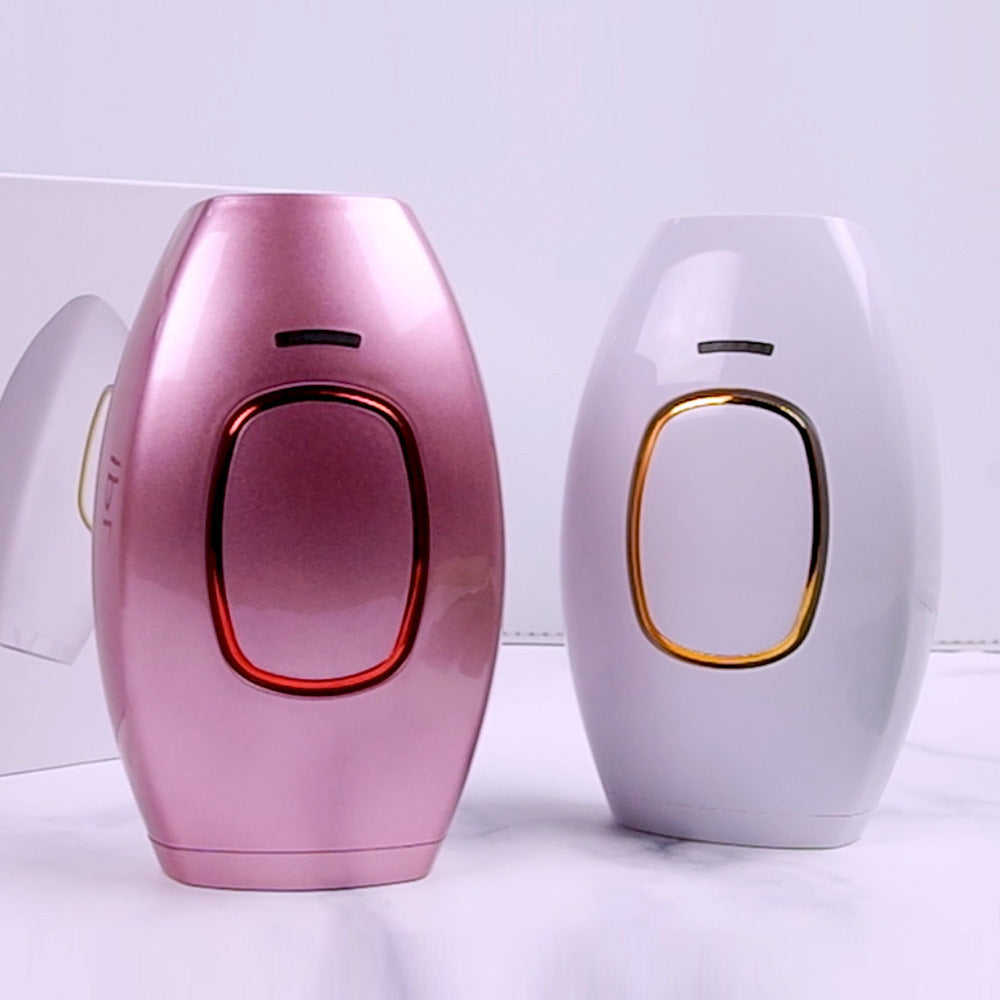 Pink and white electronic devices with gold accents on a light background