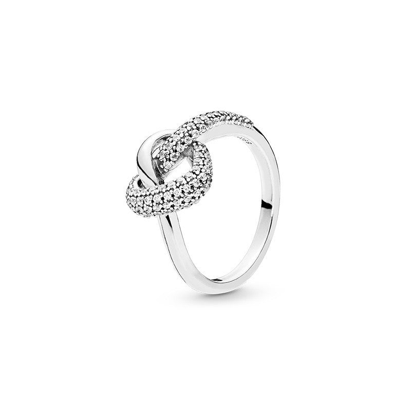 Silver ring with a heart design on a white background