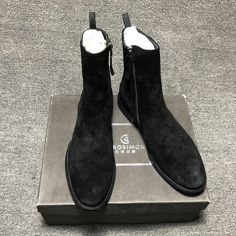 Black suede ankle boots on a Rosimon branded box against a gray textured background