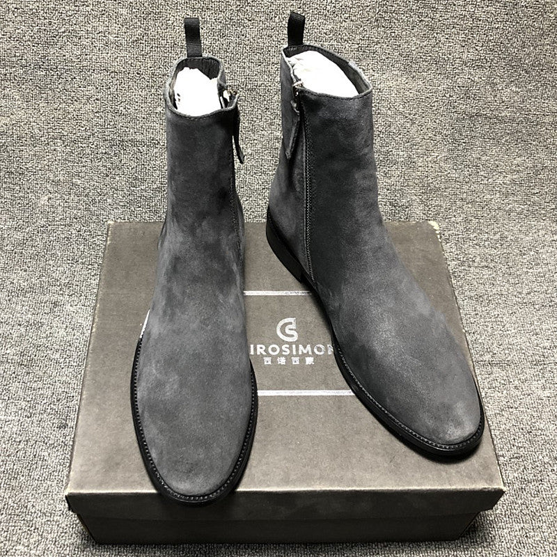 Pair of gray suede boots on a matching box with 'Girosim' branding.