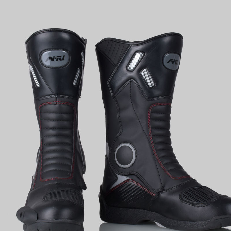 Pair of black motorcycle boots with visible brand logo on a gray background