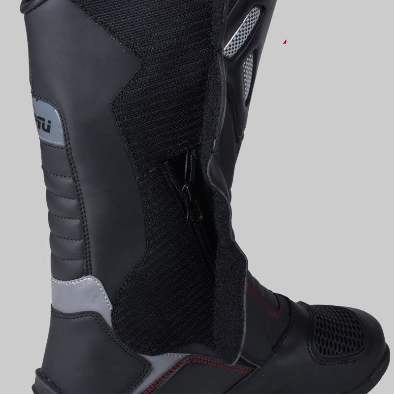 Black motorcycle boot with gray accents on a light gray background