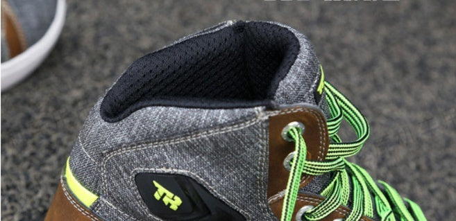 Close-up of a shoe with green laces and 'TH' logo on a textured surface